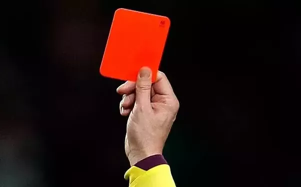 Soccer referee holding a red card