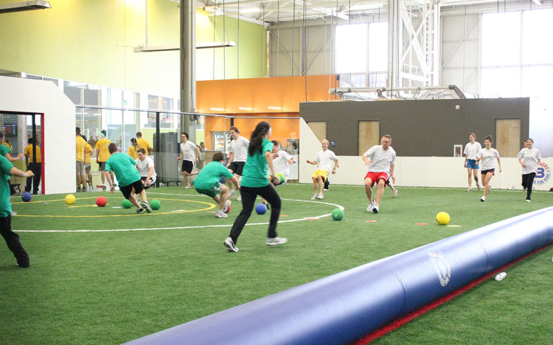 Group playing dodgeball at party event