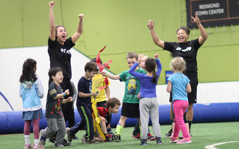 Camp coaches and kids celebrating