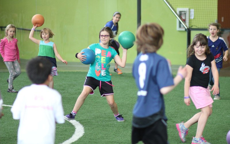 Camp girl throwing dodgeball