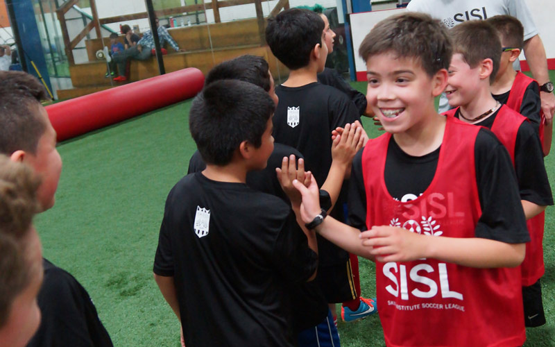 Skills Institute Soccer League boys team high-five