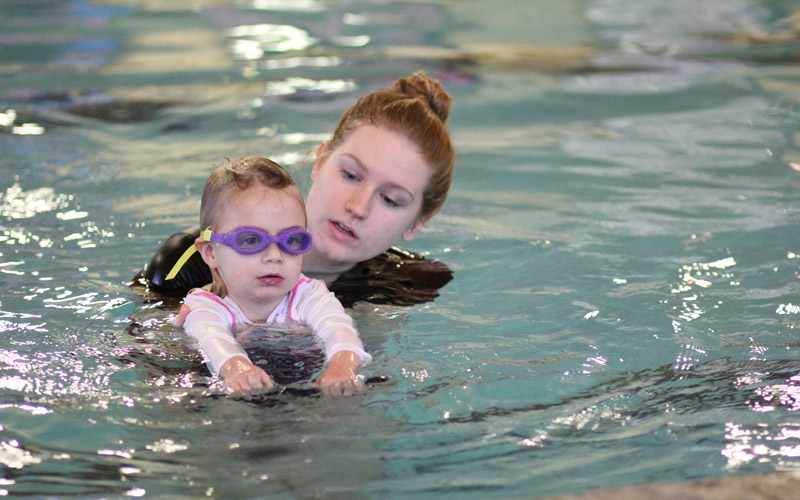 Kid in a pool learning how to swim at swim classes in Issaquah