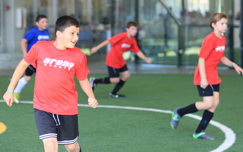Boys smiling and playing youth league soccer
