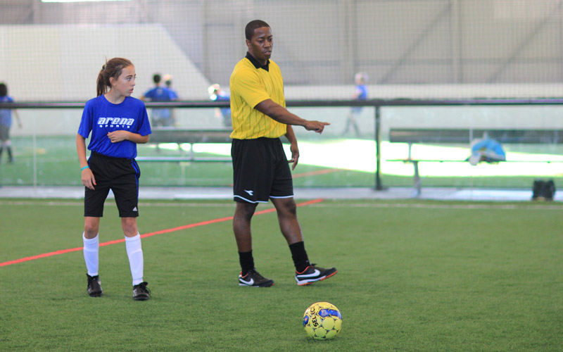 Youth league ref and girl player with soccer ball