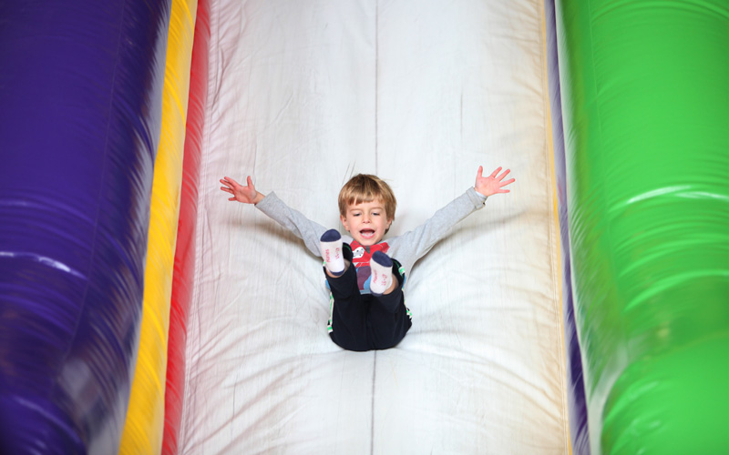 Boy sliding down Inflatable Birthday Parties