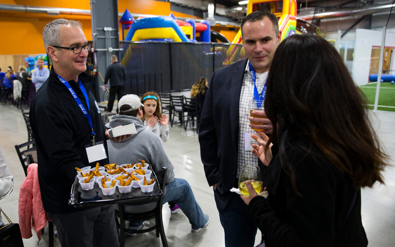 A group enjoying appetizers during a Corporate Event at Arena Sports