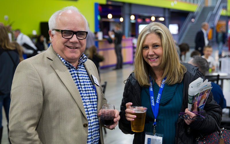 A man and woman enjoying beverages during a Corporate Event at Arena Sports in Mill Creek