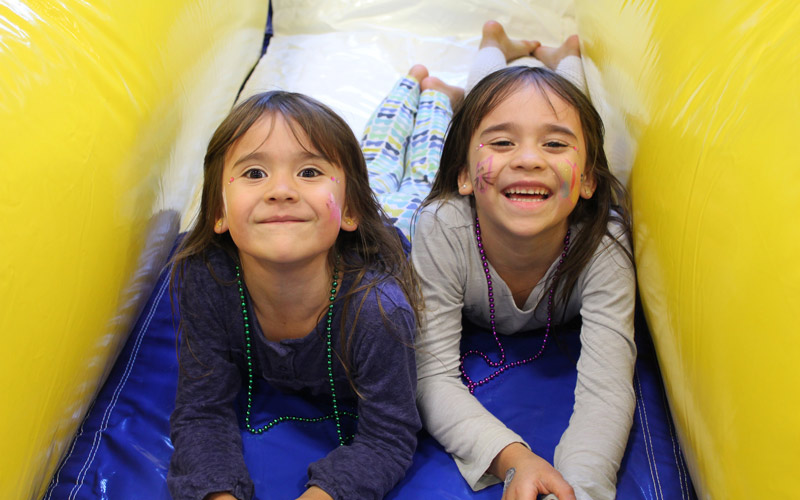 two girls blocking the slide. having fun in the funzone