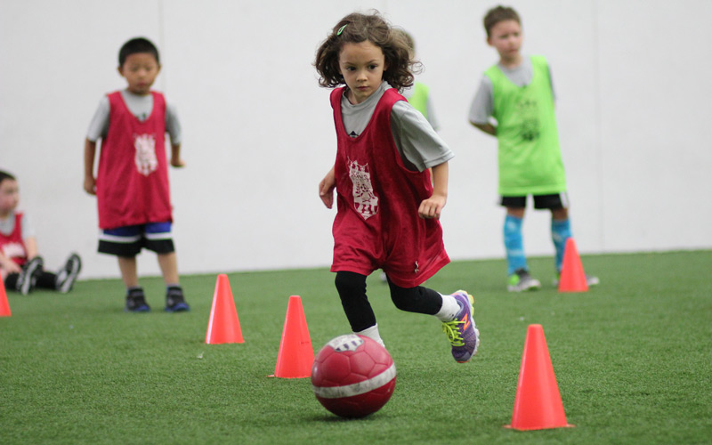 Skills Institute drills with girl dribbling ball