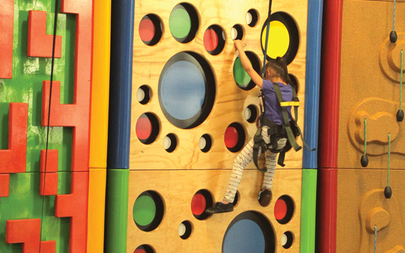 Girl on climbing wall at Arena Sports Mill Creek