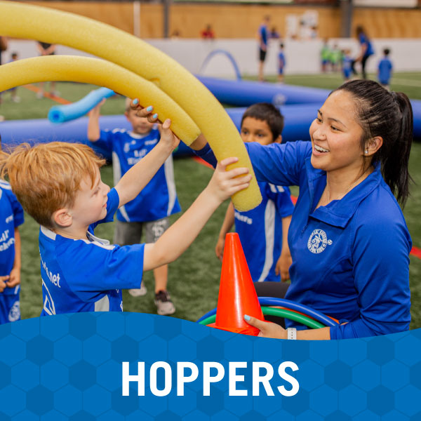 Instructor and children learn about soccer in Lil' Kickers Hoppers class