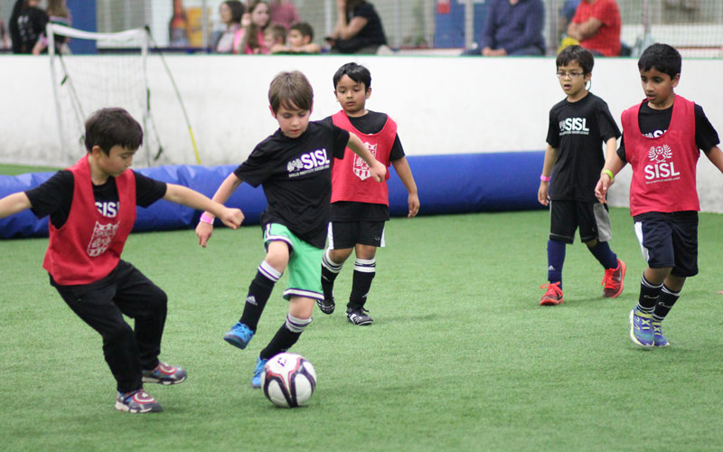 Skills Institute Soccer League boys playing indoor