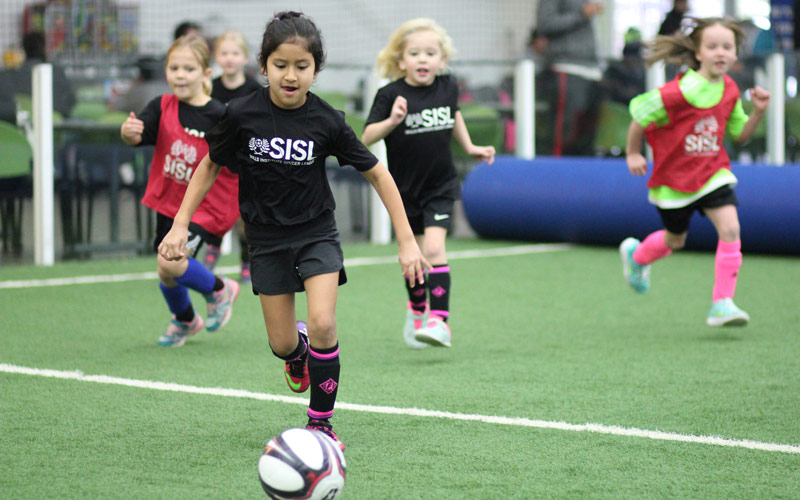 Girls kicking in soccer game