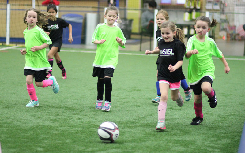 Girls playing in Skills Institute Soccer League