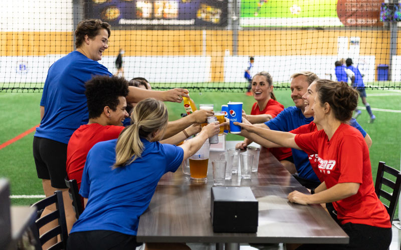 Two men playing adult league indoor soccer