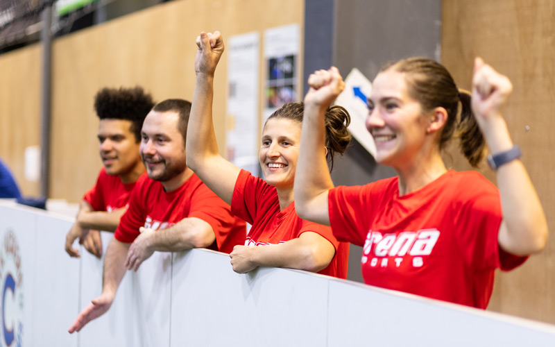 Adult Soccer Team Cheering on Sidelines