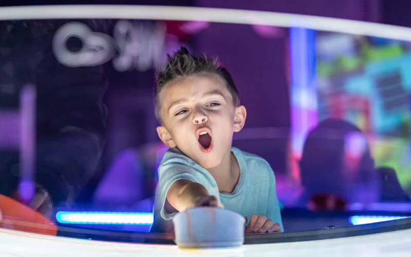 Boy playing air hockey