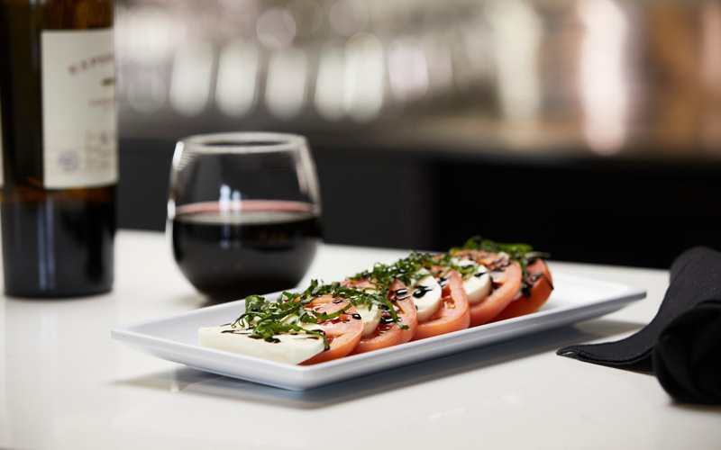 Caprese salad with a glass of red wine
