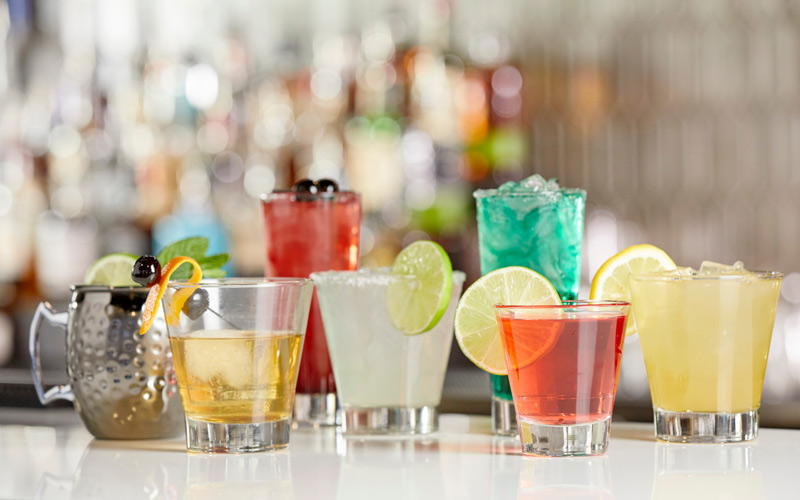 Multiple cocktails on a bar top