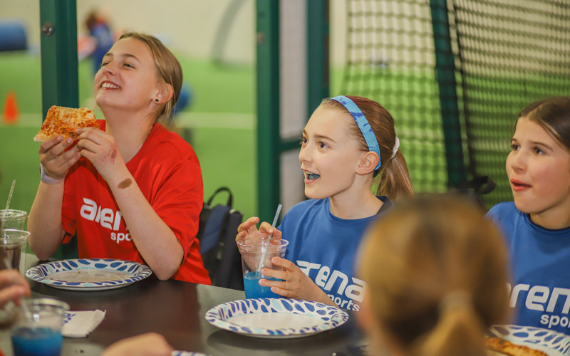 Youth League Girls Team Eating Pizza