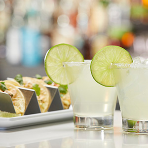 Two icy margaritas and a plate of soft tacos from the restaurant and bar at Arena Sports