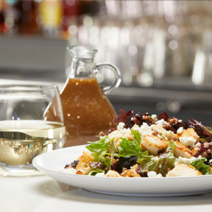 Enjoy salad and a glass of wine at the restaurant and bar at Arena Sports