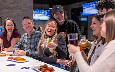 A group of adults celebrate a party in the bar at Arena Sports in Issaquah