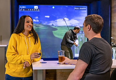 A group event held in the Sports Simulator Lounge at Arena Sports Issaquah