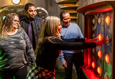 A group of adults try to solve a puzzle in the Escape Room during a Group Event at Arena Sports Issaquah