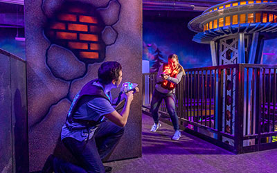 Two people play laser tag during a group event at Arena Sports Mill Creek