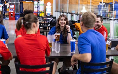 Adults in athletic clothes drink beer and water to celebrate during a Corporate Event at Arena Sports