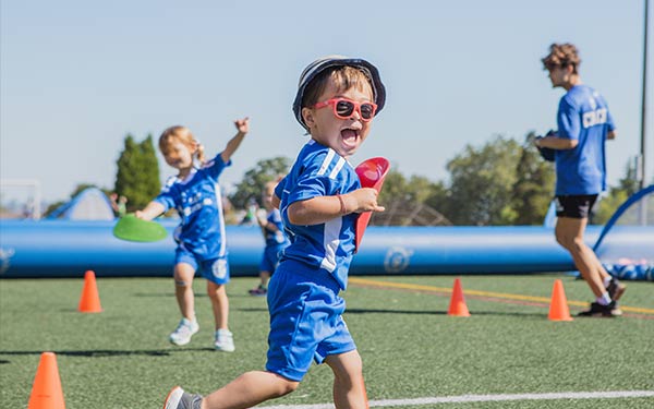Kids have fun playing soccer in a Lil' Kickers soccer class at Arena Sports