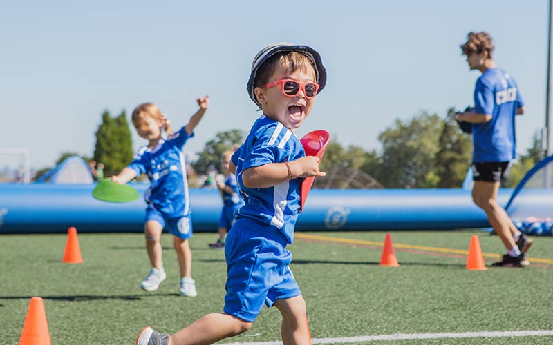 Kids in Lil Kickers uniform practice soccer drill