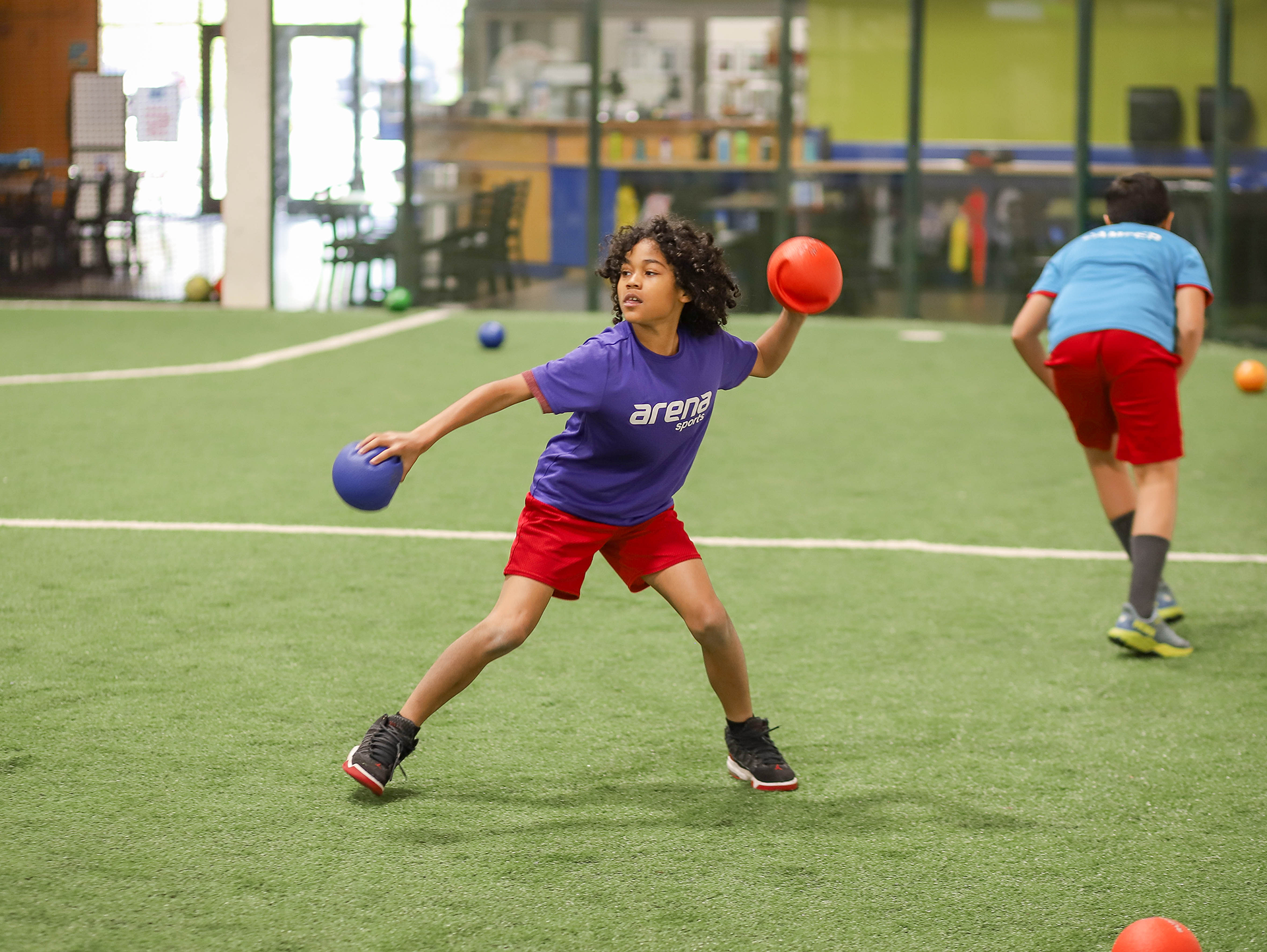 A child plays dodgeball during camp at Arena Sports