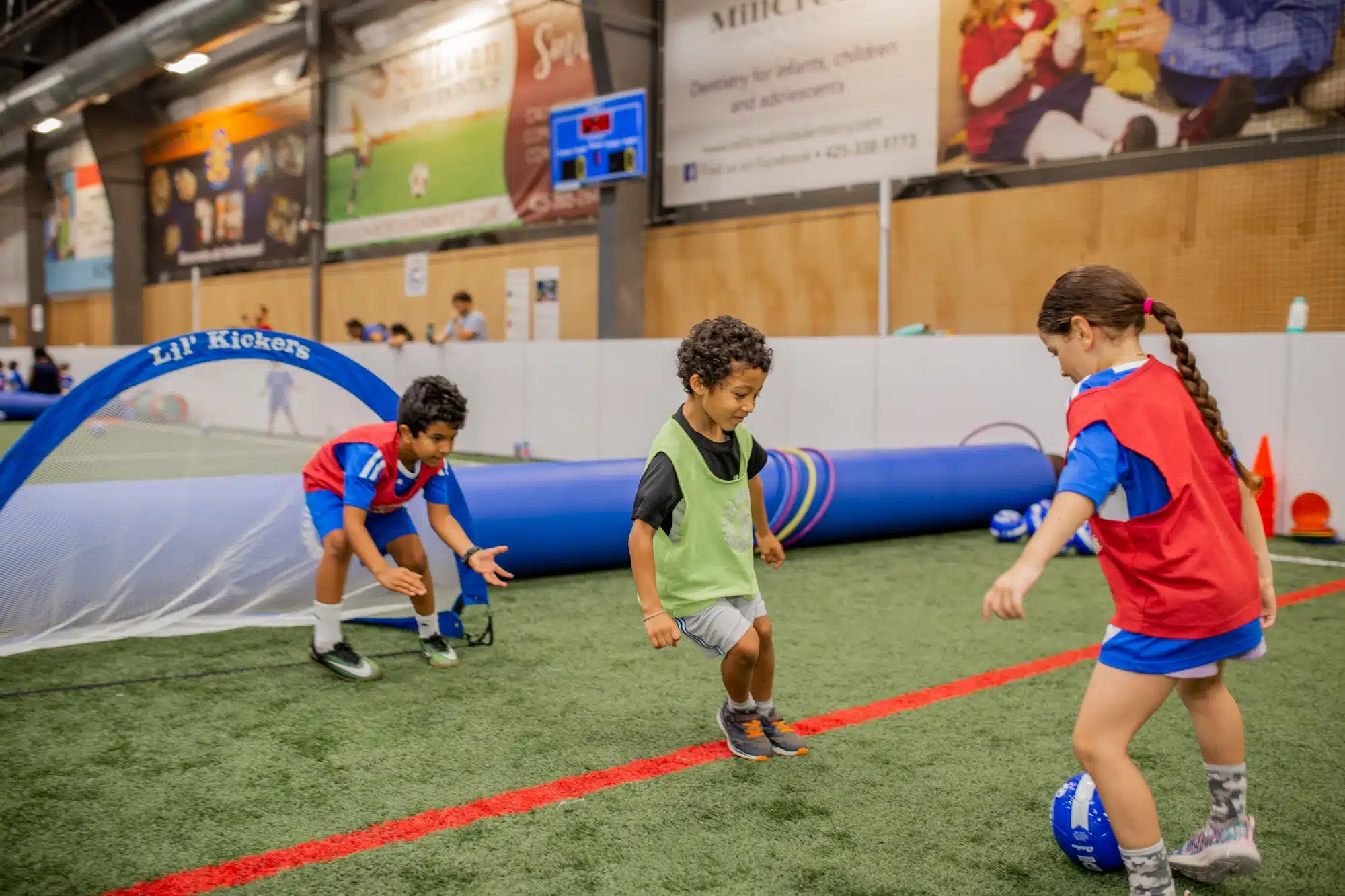 3 lil kickers playing soccer