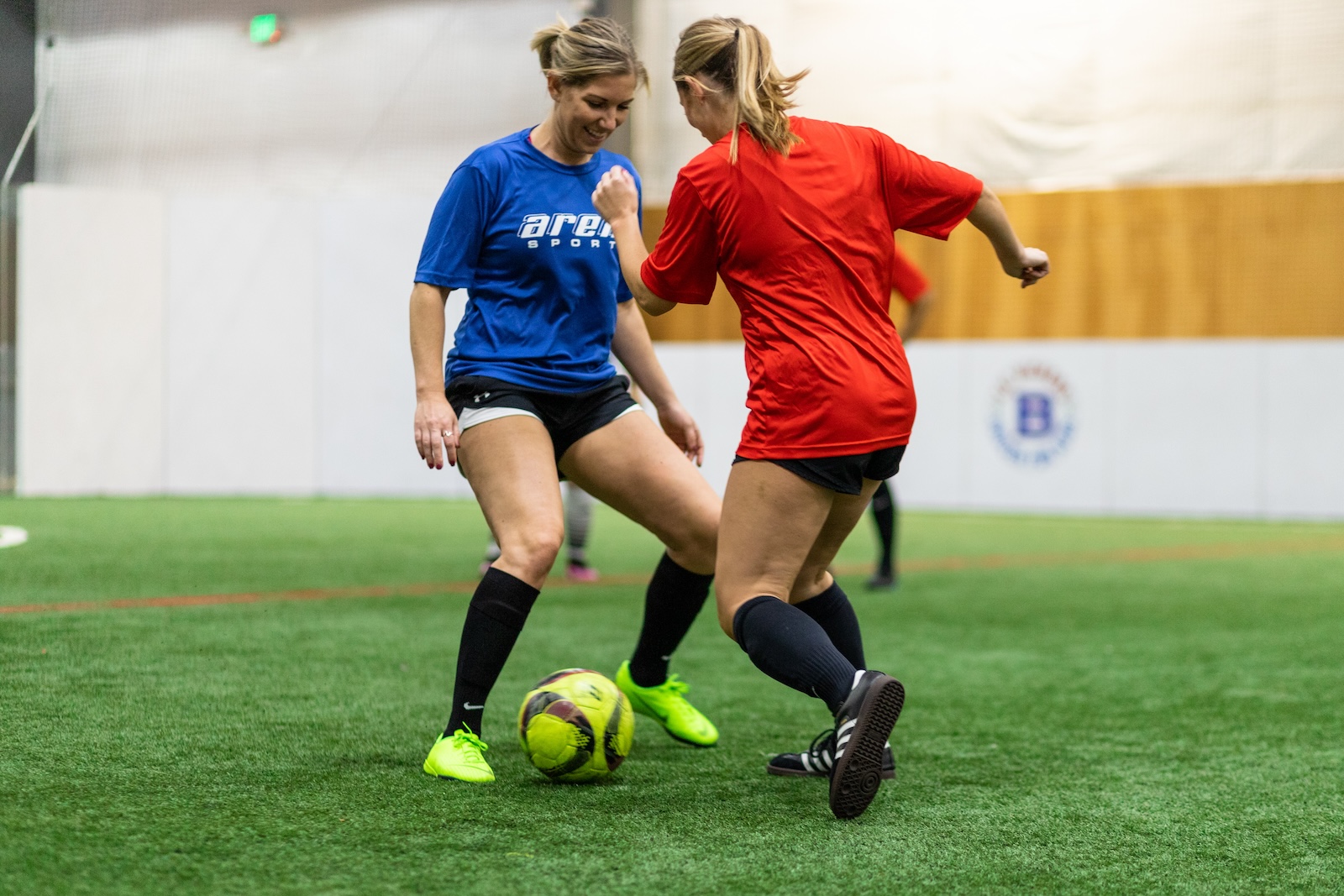 two women playing soccer