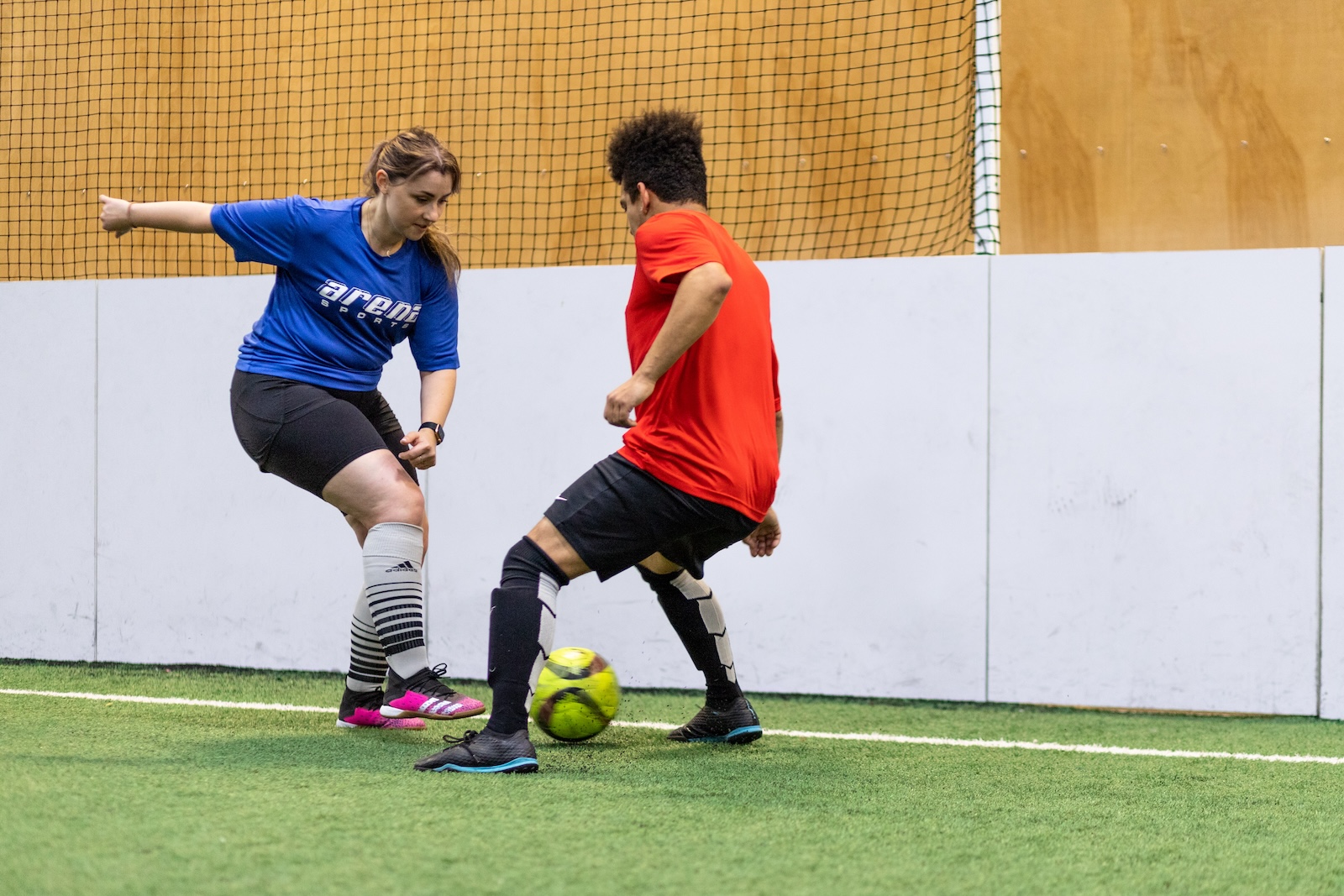woman and man playing soccer