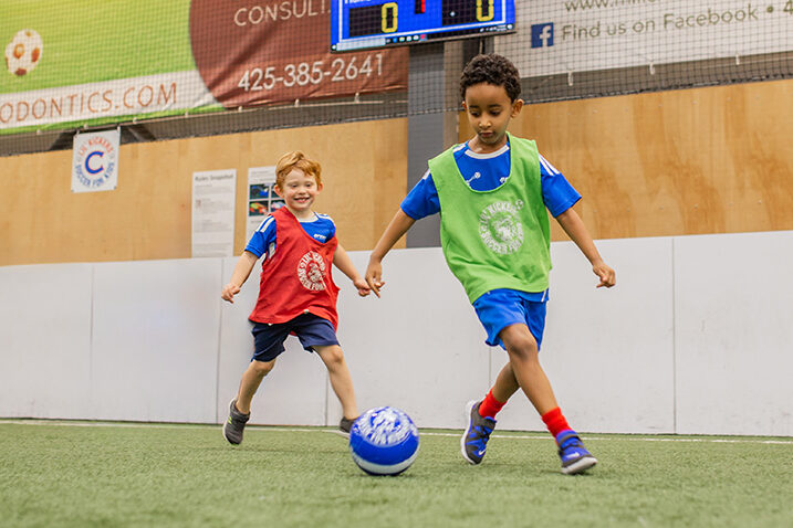 Young boys playing during Lil' Kickers soccer classes.