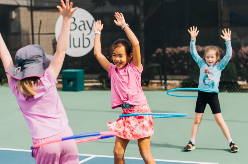 Girls hula hooping at camp